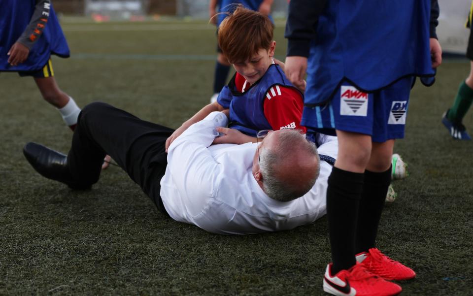 Scott Morrison channels his inner Boris Johnson as he rugby tackles a child - Asanka Ratnayake /Getty Images AsiaPac 