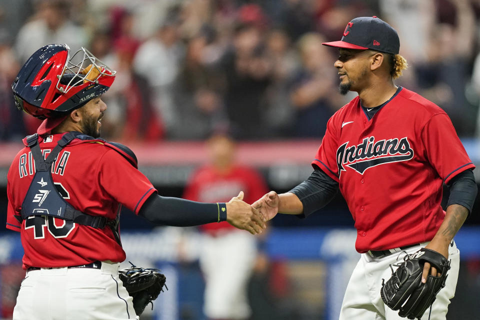 Cleveland Indians relief pitcher Emmanuel Clase, right, is congratulated by catcher Rene Rivera after they defeated the Baltimore Orioles in a baseball game, Monday, June 14, 2021, in Cleveland. (AP Photo/Tony Dejak)