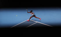 Cori "Coco" Gauff of the U.S. makes a forehand return to Romania's Sorana Cirstea during their second round singles match at the Australian Open tennis championship in Melbourne, Australia, Wednesday, Jan. 22, 2020. (AP Photo/Lee Jin-man)