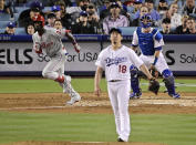 Philadelphia Phillies' Andrew McCutchen, left, runs to first as he hits a solo home run while Los Angeles Dodgers starting pitcher Kenta Maeda, center, of Japan, watches along with catcher Will Smith during the fourth inning of a baseball game Friday, May 31, 2019, in Los Angeles. (AP Photo/Mark J. Terrill)