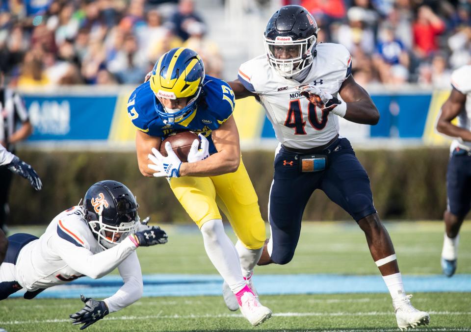 Delaware Blue Hens wide receiver Brett Buckman (13) picks up 20 yards against the Morgan State Bears linebacker Erick Hunter (40) during the first half of the homecoming football game at Delaware Stadium, Saturday, Oct. 22, 2022. Delaware won 38-7.