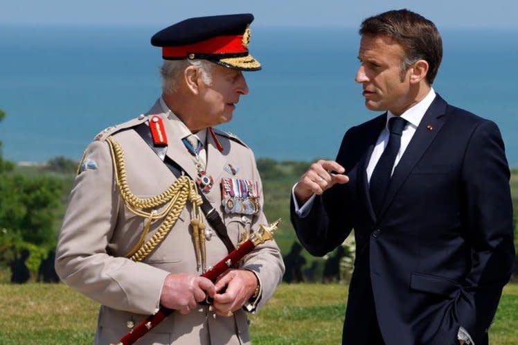 Britain's King Charles III (L) and France's President Emmanuel Macron converse during the D-Day ceremony marking the 80th anniversary of the World War II Allied landings in Normandy, at the World War II British Normandy. Photo by Ludovic Marin/EPA-EFE