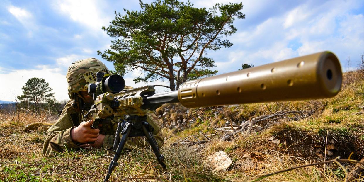 An Army paratrooper points a weapon during sniper training at Pocek Range in Postojna, Slovenia