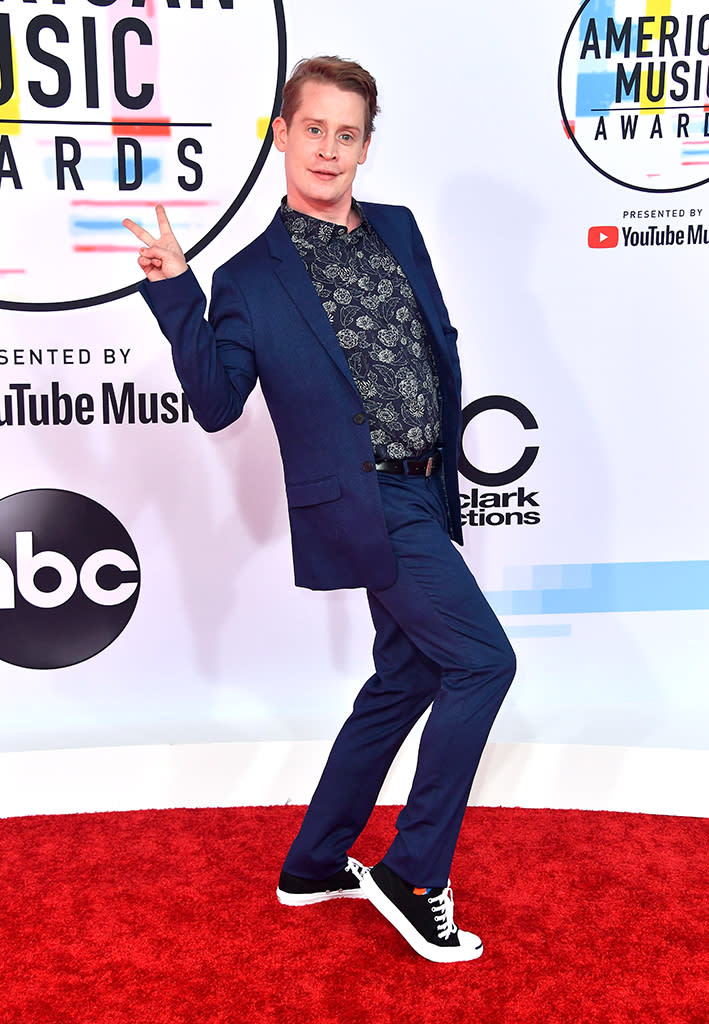 <p>While Macaulay Culkin is famous for his acting rather than music, he was excited to present on the big night. He wore a blue suit with a floral shirt underneath, and he even took off his <a rel="nofollow noopener" href="https://www.instagram.com/p/BouTqkhAu2_/?hl=en&taken-by=culkamania" target="_blank" data-ylk="slk:bunny ears" class="link ">bunny ears</a> for the occasion. (Photo: Frazer Harrison/Getty Images) </p>