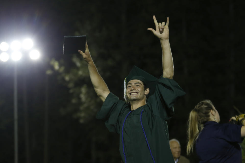 A senior celebrates after receiving his diploma during graduation ceremonies at Paradise High School in Paradise, Calif., Thursday June 6, 2019. Most of the students of Paradise High lost their homes when the Camp Fire swept through the area and the school was forced to hold classes in Chico. The seniors gathered one more time at Paradise High for graduation ceremonies. (AP Photo/Rich Pedroncelli)