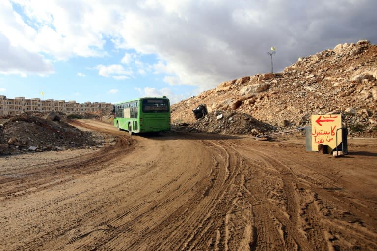 A bus drives through government-held territory in Aleppo on December 3, 2016