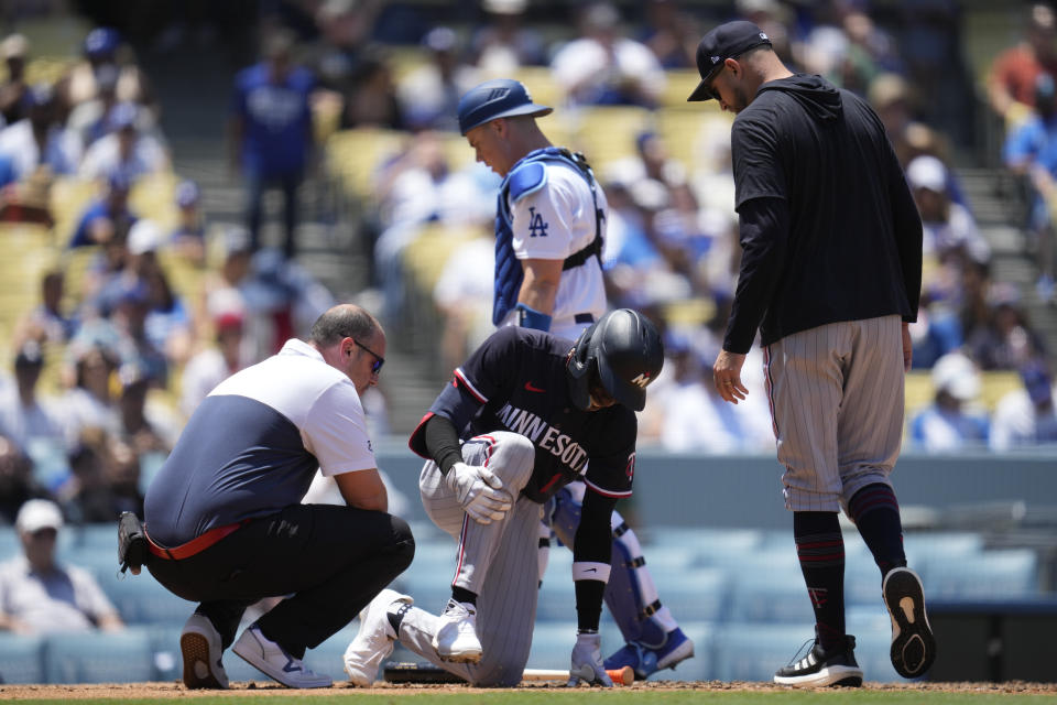 Minnesota Twins' Nick Gordon (1) is checked out for injury after he was hit by a foul ball during the fifth inning of a baseball game against the Los Angeles Dodgers in Los Angeles, Wednesday, May 17, 2023. (AP Photo/Ashley Landis)