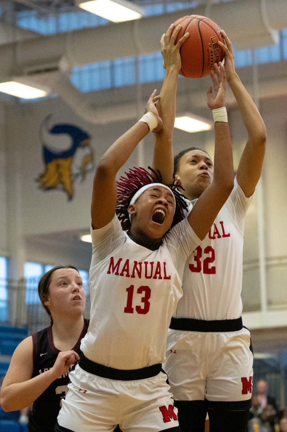 Manual's Ashlinn James (13) and Morrai Blount reach for a rebound against Assumption. James scored a game-high 17 points Wednesday night in a Seventh Region semifinal victory.
