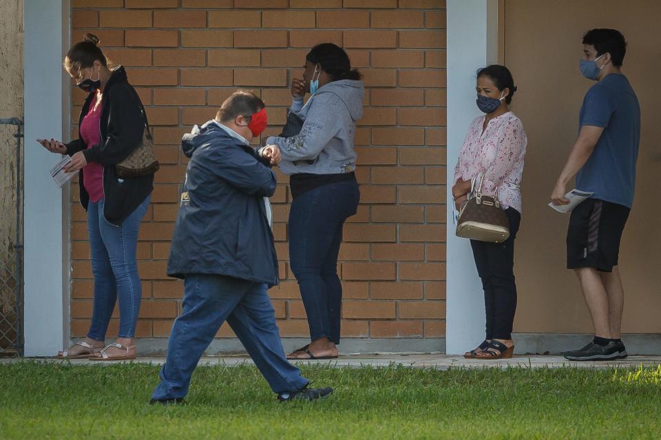 A few dozen voters wait in line at Palm Beach County voting precinct 3010 at Faith Presbyterian Church in Palm Springs, Fla., on Election Day, Nov. 3, 2020.