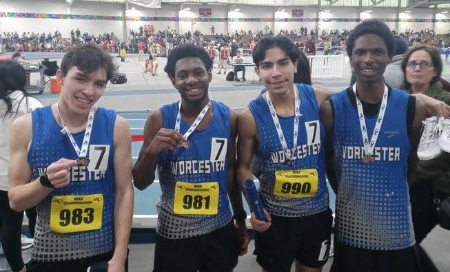 Worcester Tech's Michael Amadou, Carlo Vallejos, Brian Boateng and Gabriel Palomeque-Jara celebrate breaking a school record in the 3,200 relay on Sunday at the Reggie Lewis Center in Boston.