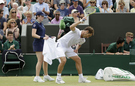 Richard Gasquet of France smashes his racket after losing the third set during his match against Nick Kyrgios of Australia at the Wimbledon Tennis Championships in London, July 6, 2015. REUTERS/Henry Browne