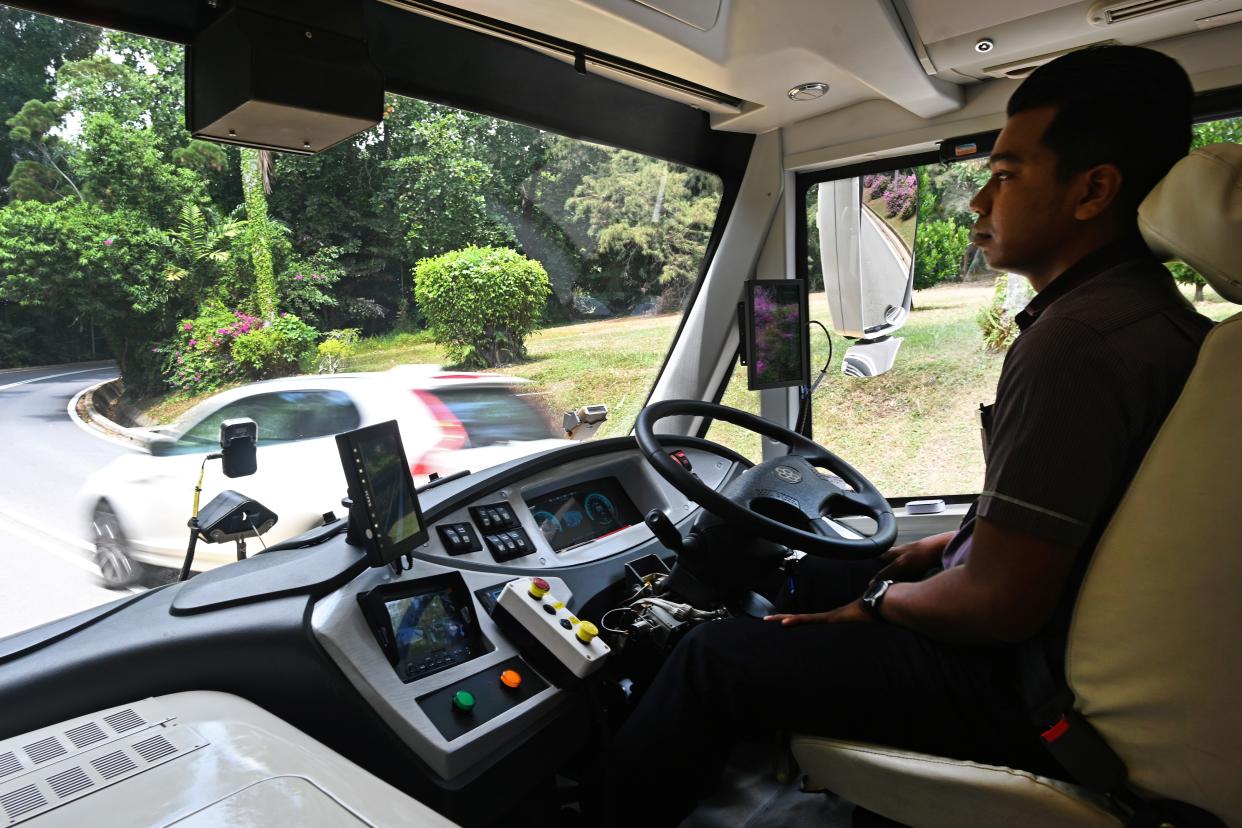 A safety driver sits in a moving on-demand autonomous shuttle bus during the official launch of a public trial run at Sentosa island resort in Singapore on August 20, 2019. - Singapore will next week begin a public trial of driverless buses that can be booked with an app, part of ambitions to roll out autonomous vehicles across the city-state. (Photo by Roslan RAHMAN / AFP)        (Photo credit should read ROSLAN RAHMAN/AFP/Getty Images)