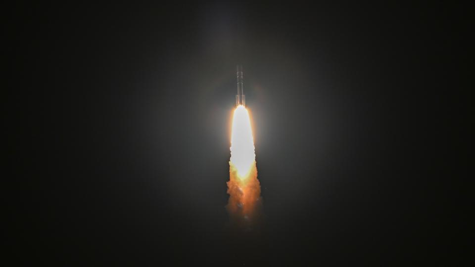 Vulcan rocket launch showing rocket against a black sky with billowing flames from the engines below