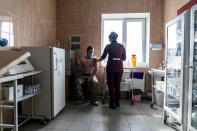 A Ukrainian serviceman receives a dose of the AstraZeneca COVID-19 vaccine marketed under the name CoviShield at a military base in Kramatorsk, Ukraine, Tuesday, March 2, 2021. Ukraine plans to vaccinate 14.4 million people this year, or about 35% of its 41 million people. (AP Photo/Evgeniy Maloletka)