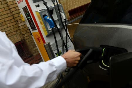 An electric car charges at the Holloway Road Shell station where Shell is launching its first fast electric vehicle charging station in London, Britain October 18, 2017. REUTERS/Mary Turner