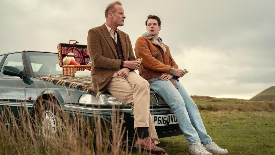 Adam and Mr Groff having a picnic on the hood of a car in Sex Education season 4