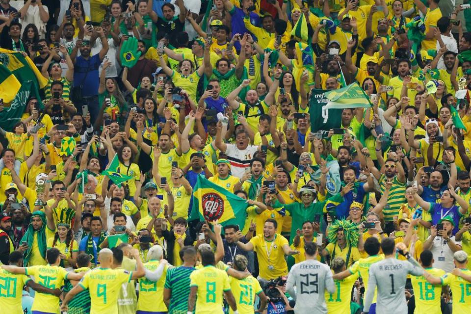 Brazil players celebrate with their fans after the final whistle.