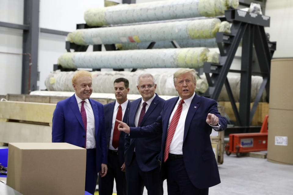 President Donald Trump speaks as Australian Prime Minister Scott Morrison, center, and Pratt Industries chairman Anthony Pratt, left, watch during a tour of Pratt Industries, Sunday, Sept 22, 2019, in Wapakoneta, Ohio. (AP Photo/Evan Vucci)