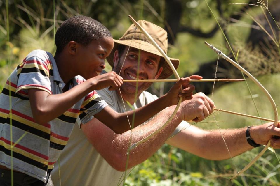 In this undated image released by Animal Planet, survivalist Guy Grieve, right, uses bow and arrow during the filming of "The Hunger," a new adventure series that explores the ingenious methods used by disparate world cultures to find, capture, cultivate and consume food. (AP Photo/Animal Planet)