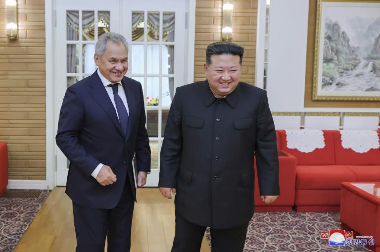 North Korean state media showed leader Kim Jong Un (R) meeting with Russia's Security Council Secretary Sergei Shoigu at an undisclosed location (STR)