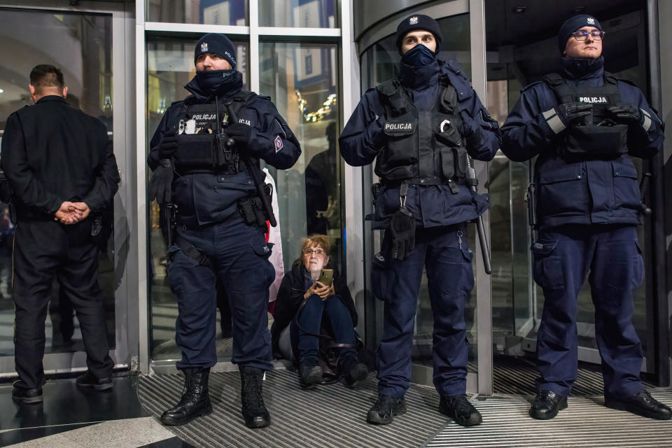 Police officers block the entrance to TVP headquarters during a sit-in protest