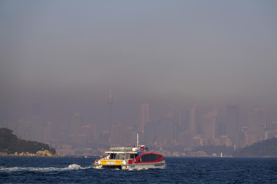 A passenger ferry leaves a wharf at Watsons Bay as a thick a blanket of smoke hangs over parts of the Sydney following New South Wales Rural Fire Service (RFS) hazard reduction burns in the past week, Thursday, Sept. 14, 2023. The NSW Rural Fire Service and National Parks and Wildlife Service are burning over 600 hectares around Sydney before an expected hot weekend that will begin a run of high temperatures and increased fire risk. (AP Photo/Mark Baker)