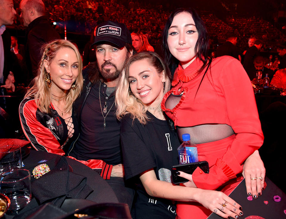 <p>In March, Miley was playing the role of supportive sister when Noah took to the stage for her debut performance at the iHeartRadio Music Awards. Not only did the future Mrs. Liam Hemsworth introduce her sis, but she held up an “I love Noah Cyrus” sign in the audience. They also posed, along with mom and dad, for photographers. (Photo: Kevin Mazur/Getty Images for iHeartMedia) </p>