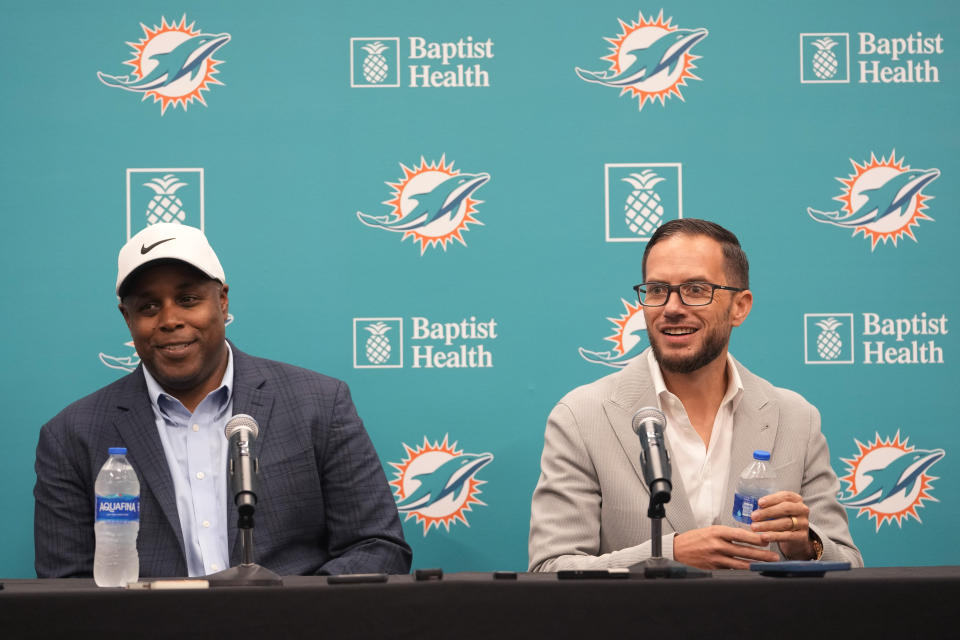 Miami Dolphins general manger Chris Grier, left, and head coach Mike McDaniel, right, listen to questions at a news conference during the NFL draft, Friday, April 28, 2023, at the football team's training center in Miami Gardens, Fla. (AP Photo/Lynne Sladky)