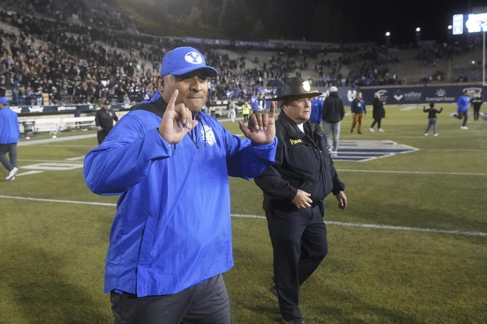 BYU head coach Kalani Sitake celebrates as he walks off the field following their NCAA college football game against Utah State Friday, Oct. 1, 2021, in Logan, Utah. (AP Photo/Rick Bowmer)