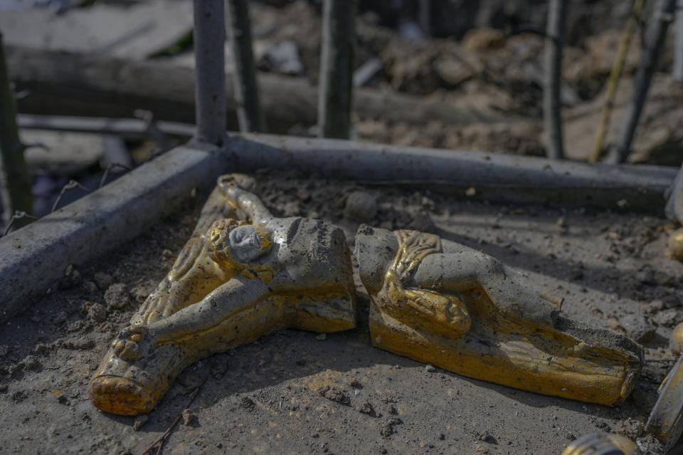 A small  destroyed monument of Jesus,  is seen in front of a house hit by Russian rocket at Zelenyi Hai village between Kherson and Mykolaiv, less than 5km to front line on 1 April 2022 (AFP via Getty Images)