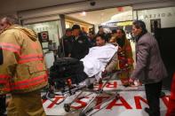 A passenger is wheeled on a stretcher through Terminal D by emergency medical services workers at LaGuardia Airport in New York March 5, 2015. REUTERS/Shannon Stapleton