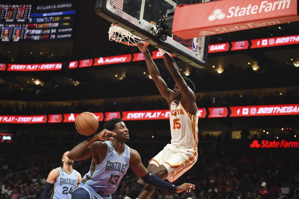 Atlanta Hawks center Clint Capela dunks over Memphis Grizzlies forward Jaren Jackson Jr. during the second half of an NBA basketball game, Sunday, March 26, 2023, in Atlanta. (AP Photo/Hakim Wright Sr.)