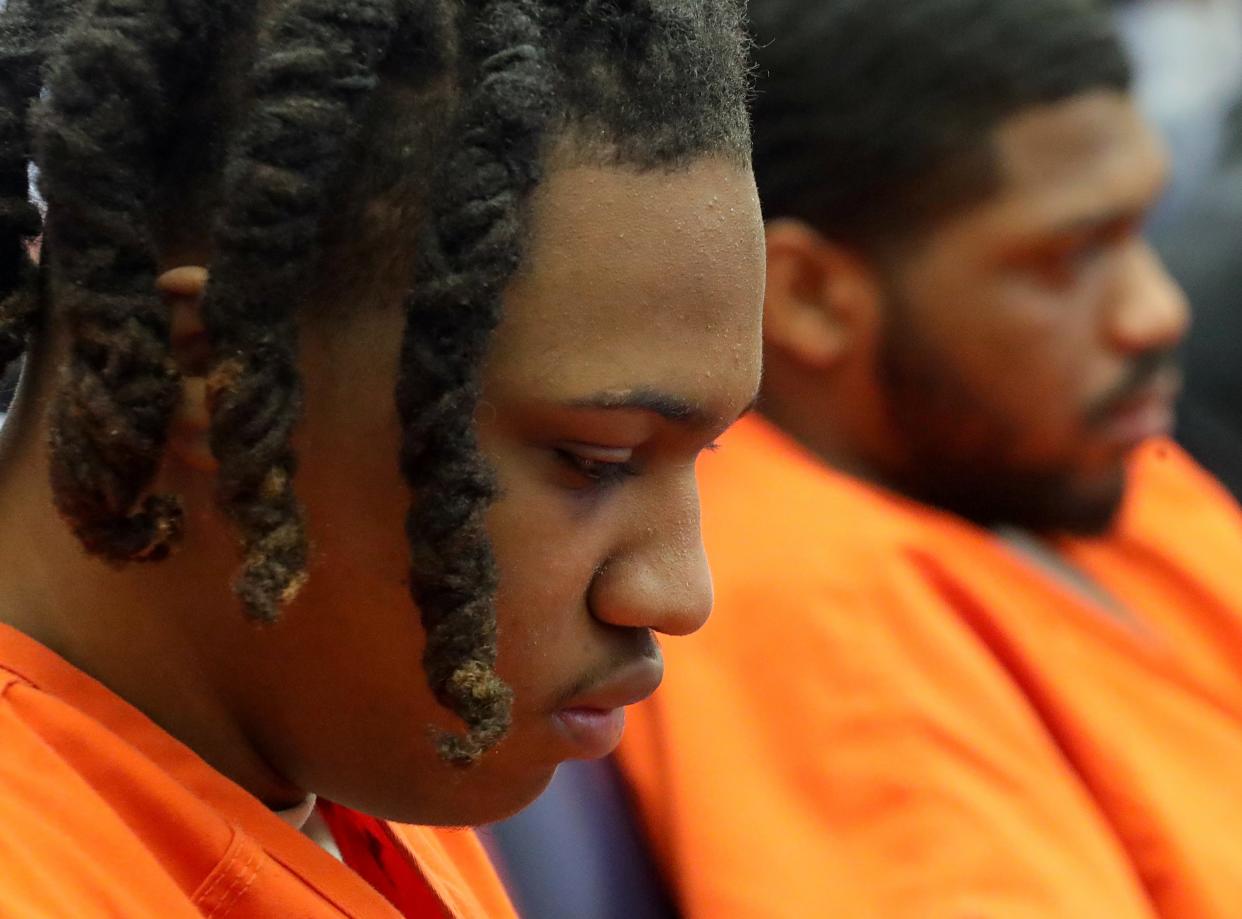 Layveire Belton, who pleaded guilty to aggravated robbery and a gun specification, lowers his head as he listens to Damarcus Hartwell's family speak before receiving his sentence for his role in the 2022 shooting death of Hartwell in Judge Joy Malek Oldfield's courtroom at the Summit County Courthouse.
