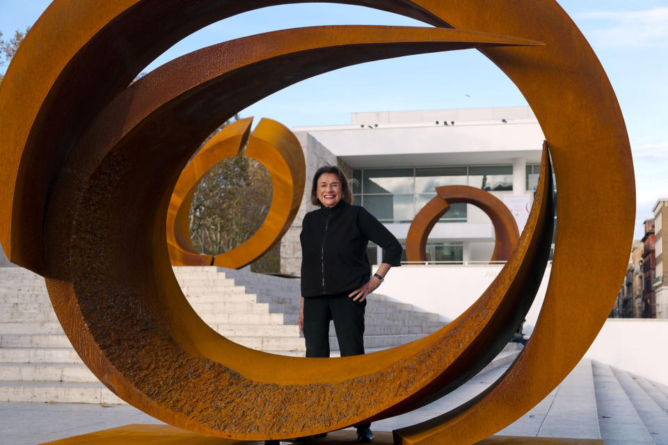 FILE -- In this Dec. 2, 2014 file photo U.S. artist and sculptor Beverly Pepper poses with her latest sculptures part of the 'Curvae in Curvae' series on display in front of the Ara Pacis Museum in downtown Rome. Pepper, an acclaimed American sculptor, died Wednesday at her home in Todi, Italy. She was 97. (AP Photo/Domenico Stinellis)