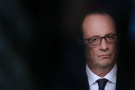 French President Francois Hollande listens as he attends a joint declaration with Philippines President at the Elysee Palace in Paris September 17, 2014. REUTERS/Christian Hartmann