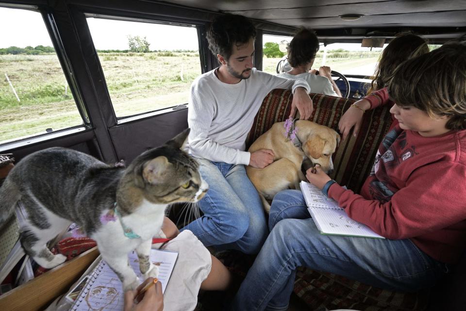 Argentinian Zapp family travels alonside its dog Timon, and its cat Hakuna, in its car, a 1928 Graham-Paige, near Gaualeguaychu, Entre Rios province, Argentina, on March 10, 2022. - The family expects to finish on Sunday a 22 year-journey arround the world that started on January 23, 2000 at the Republica square in Buenos Aires. (Photo by JUAN MABROMATA / AFP) (Photo by JUAN MABROMATA/AFP via Getty Images)