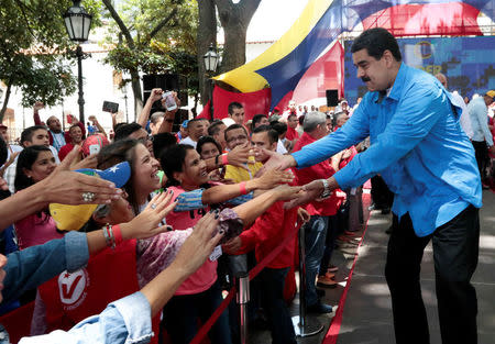 Venezuela's President Nicolas Maduro (R) greets supporters during an event in Caracas, Venezuela July 3, 2017. Miraflores Palace/Handout via REUTERS