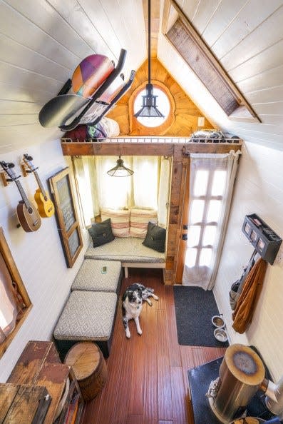 An aerial photo of Jenna Spesard's living room in her tiny house with a dog laying on the floor