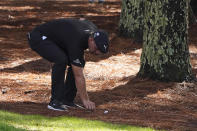 Bryson DeChambeau moves pine straw next to his ball on the 13th hole during the first round of the Masters golf tournament Thursday, Nov. 12, 2020, in Augusta, Ga. (AP Photo/Chris Carlson)