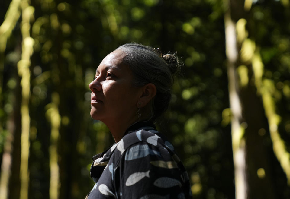 Amelia Marchand, citizen of the Confederated Tribes of the Colville Reservation, poses for a portrait at NatureBridge in the Olympic National Park during the 2023 Tribal Climate Camp, Thursday, Aug. 17, 2023, near Port Angeles, Wash. Participants representing at least 28 tribes and intertribal organizations gathered to connect and share knowledge as they work to adapt to climate change that disproportionally affects Indigenous communities. More than 70 tribes have taken part in the camps that have been held across the United States since 2016. (AP Photo/Lindsey Wasson)