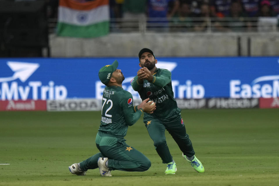 Pakistan's Khushdil Shah, left, takes the catch to dismiss India's captain Rohit Sharma during the T20 cricket match of Asia Cup between India and Pakistan, in Dubai, United Arab Emirates, Sunday, Sept. 4, 2022. (AP Photo/Anjum Naveed)