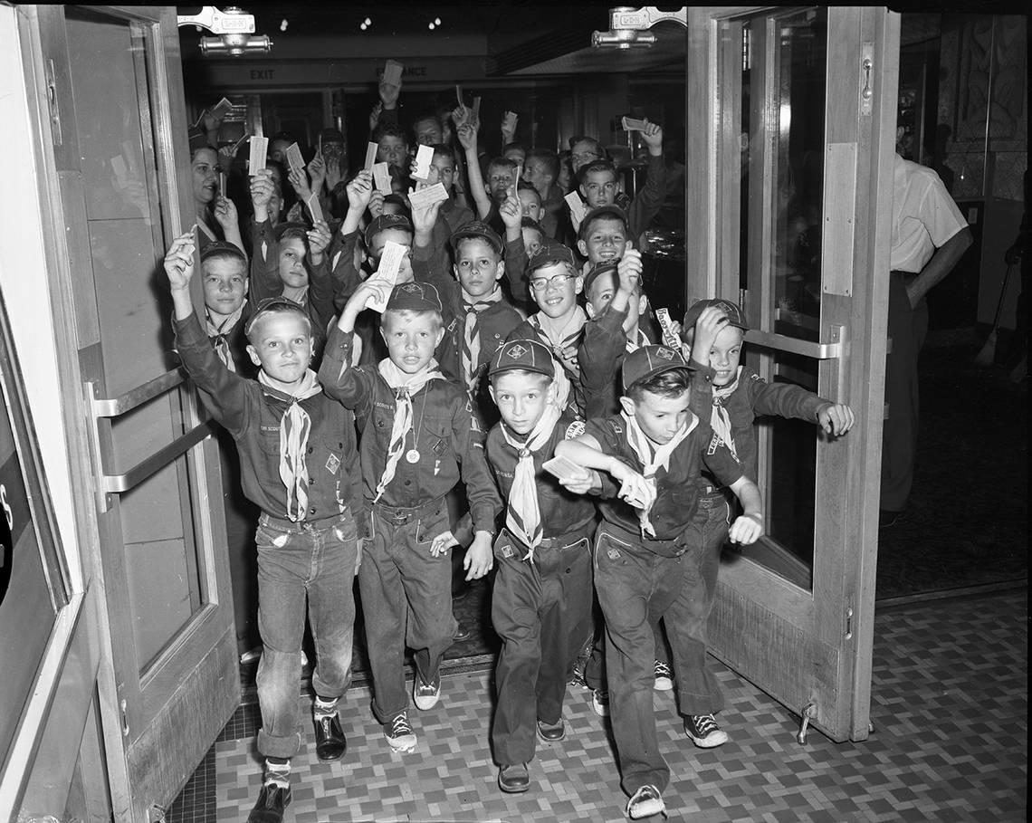 April 22, 1954: A small section of Boy Scouts scurry out of the Worth Theater to start their downtown ticket selling invasion. Tickets are for the scouting in Action Exposition to be held May 7-8 at Will Rogers Exhibit Building. Five hundred scout attended a pep rally before starting the ticket sales. Proceeds aid Worth Ranch. Fort Worth Star-Telegram archive/UT Arlington Special Collections