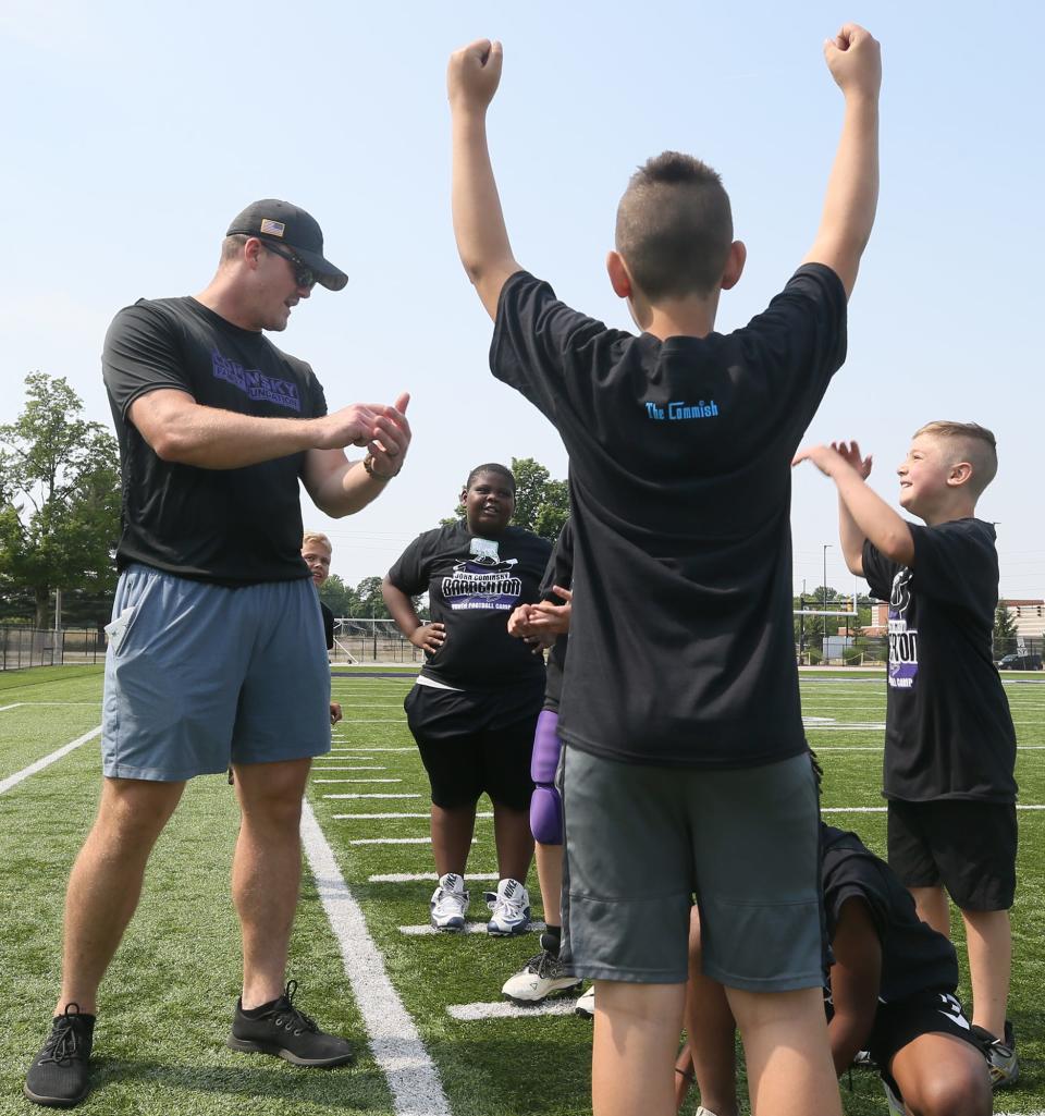 John Cominsky, a former Barberton standout and current Detroit Lion, talks with campers Saturday during the John Cominsky Youth Football Camp at Rudy Sharkey Stadium in Barberton.