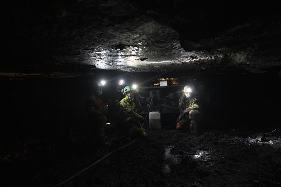 Coal miners refill a machine with oil at the bottom of the Gruve 7 coal mine in Adventdalen, Norway, Monday, Jan. 9, 2023. The last Norwegian coal mine in Svalbard – an archipelago that's one of the world's fastest warming spots – was slated to close this year and only got a reprieve until 2025 because of the energy crisis driven by the war in Ukraine. (AP Photo/Daniel Cole)