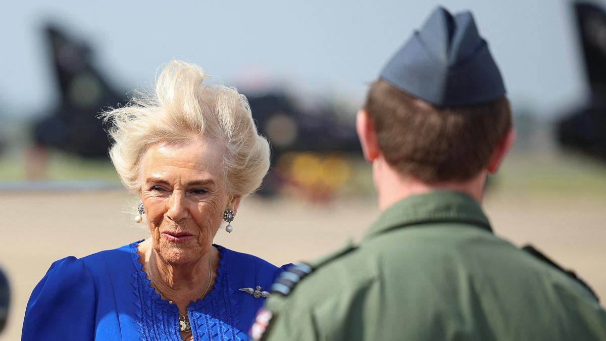 Windy welcome for Camilla as she visits allotment on air base