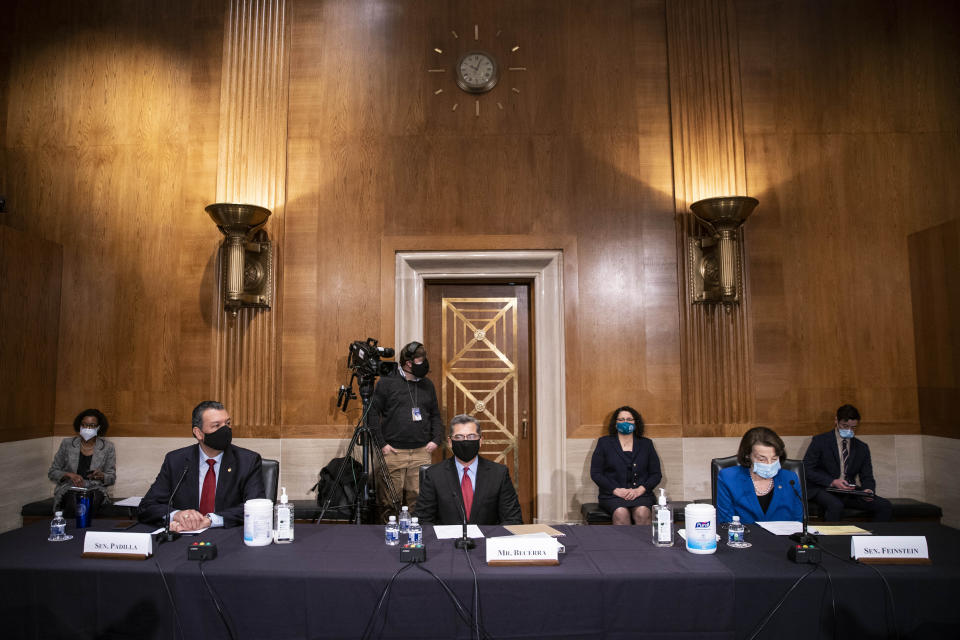 Xavier Becerra, center, listens during a confirmation hearing to be Secretary of Health and Human Services before the Senate Health, Education, Labor and Pensions Committee, Tuesday, Feb. 23, 2021 on Capitol Hill in Washington. Seated with Becerra are Sen. Alex Padilla, D-Calif., left, and Sen. Dianne Feinstein, D-Calif. (Sarah Silbiger/Pool via AP)