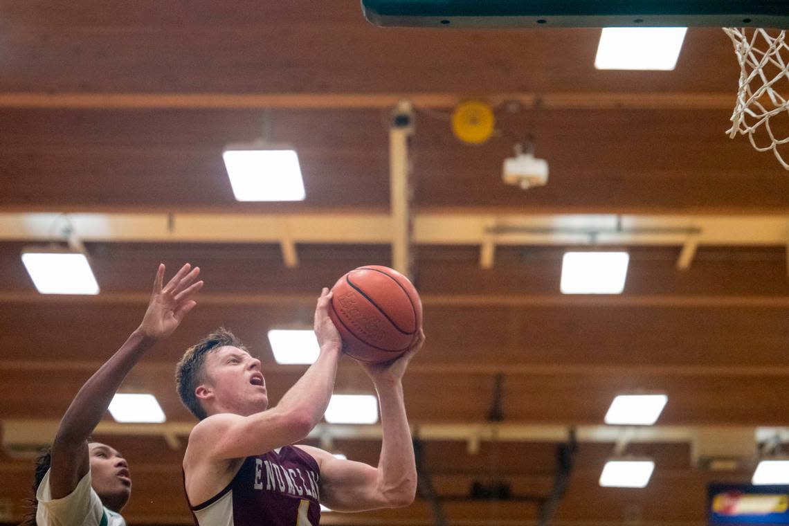 Enumclaw guard Noah Seabrands hangs in the air as he attempts a layup while Foss’s Keshawn Lewis defends during the fourth quarter of 2A SPSL game on Tuesday, Jan. 24, 2023, in Tacoma, Wash.
