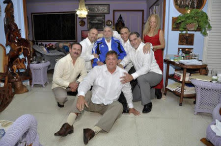 Cuba's former President Fidel Castro (C, in blue jacket) and his wife Dalia Soto Del Valle (R, in red dress) pose for a photograph with the so-called "Cuban Five" Ramon Labanino (C, front), Fernando Gonzalez (L), Gerardo Hernandez (2nd L), Antonio Guerrero (3rd R) and Rene Gonzalez (2nd R) in this picture provided by Cubadebate. Castro, 88, finally met with all five of the Cuban spies who returned home as heroes after serving long prison terms in the United States, 73 days after the last of them were freed in a prisoner swap. REUTERS/Cubadebate/Handout via Reuters