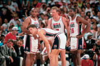 BARCELONA, SPAIN - 1992: (L-R) Charles Barkley, Christian Laettner, Larry Bird #7 and Magic Johnson #15 of the United States National Team discuss strategy during the1992 Summer Olympics in Barcelona, Spain.