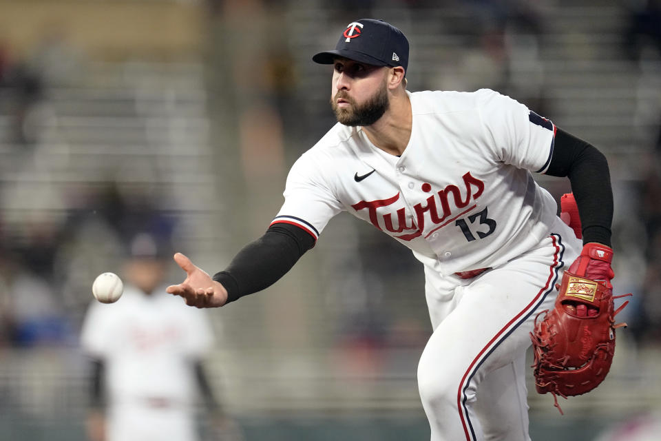 Minnesota Twins first baseman Joey Gallo (13) throws to first base to get out New York Yankees' Aaron Hicks during the sixth inning of a baseball game Monday, April 24, 2023, in Minneapolis. (AP Photo/Abbie Parr)